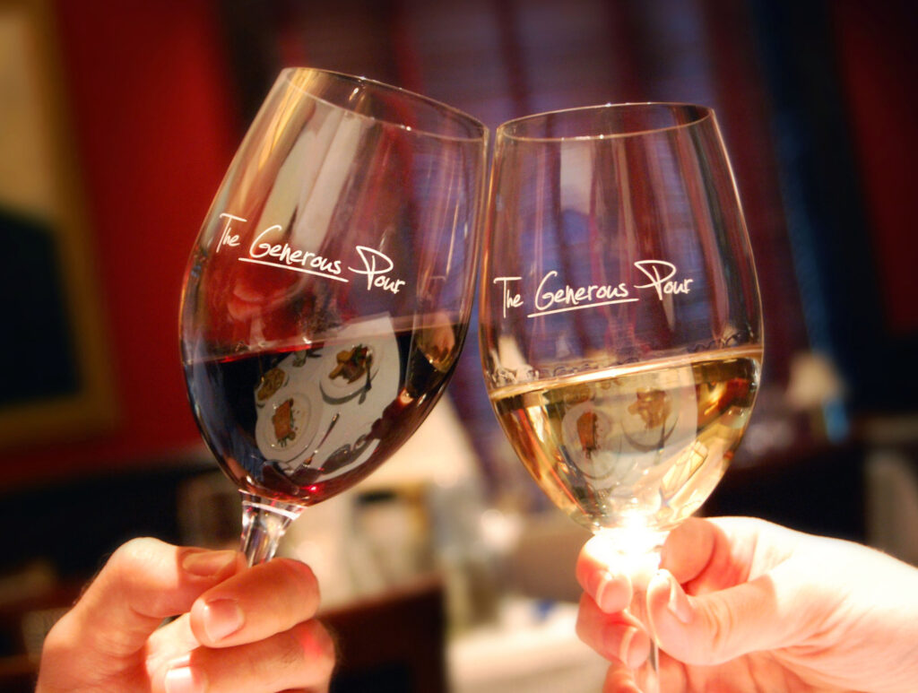 Two wine glasses clinking