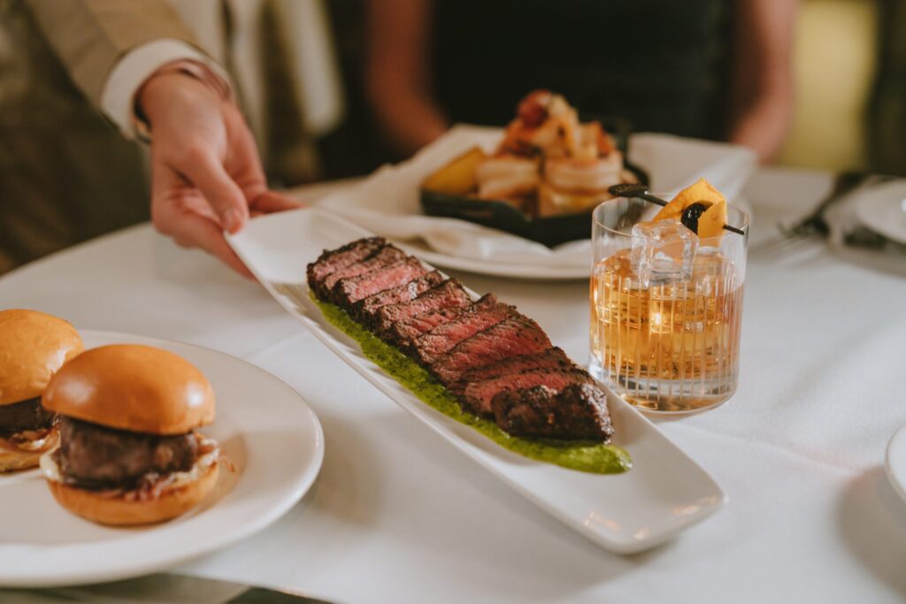 Plates of food and a cocktail